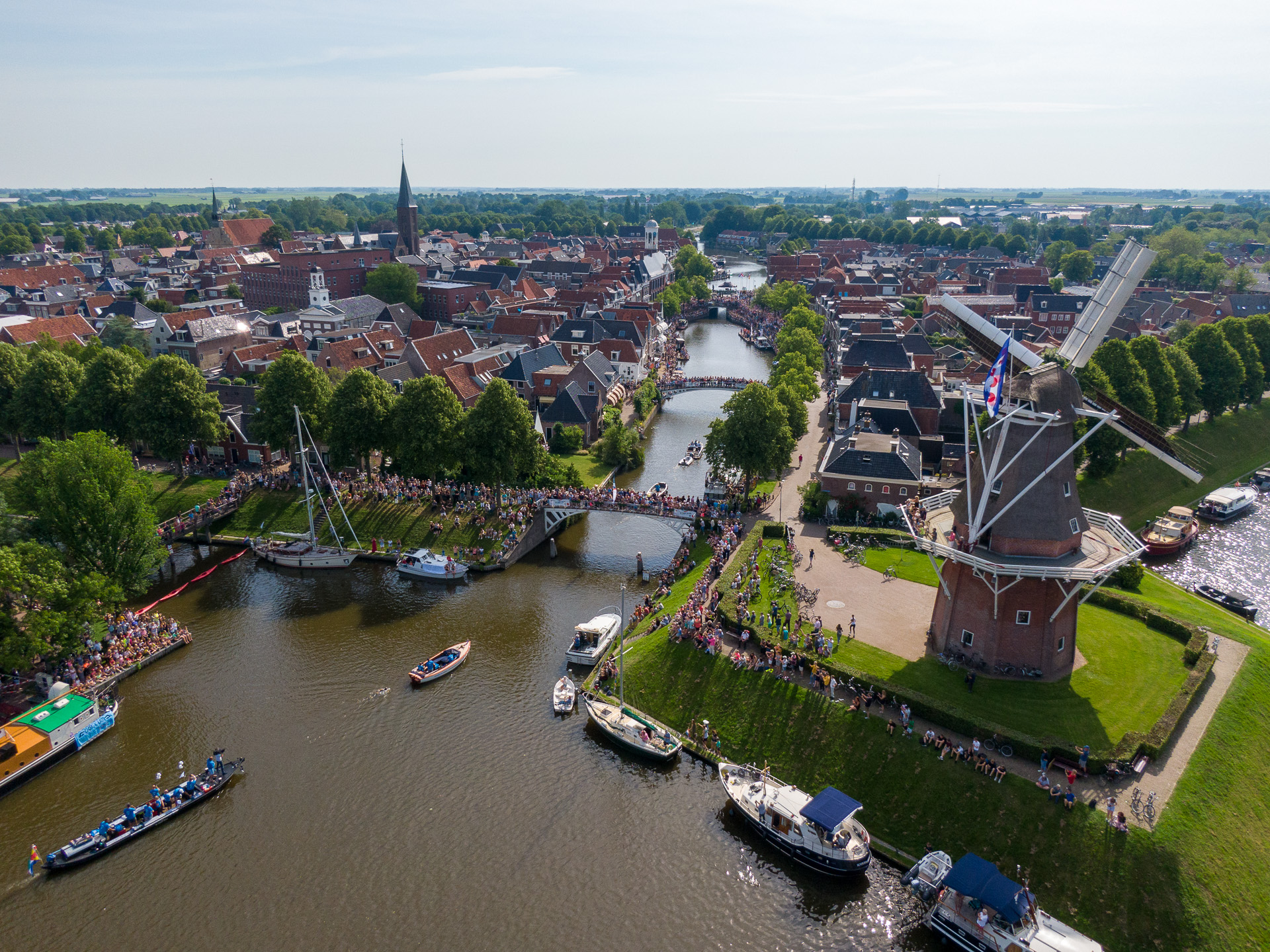 Een stad aan het water met een molen vanuit de lucht